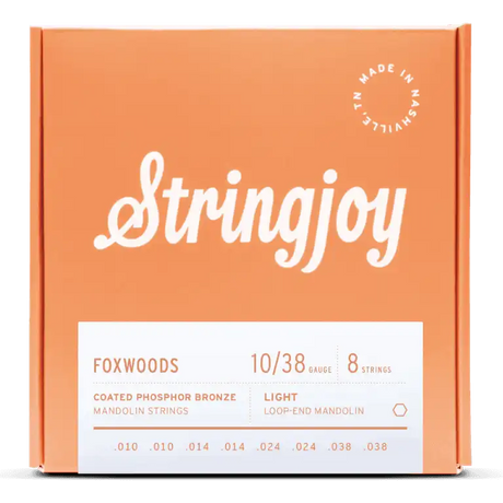 The image shows a package of Stringjoy Foxwoods coated phosphor bronze mandolin strings, light gauge 10-38, with 8 loop-end strings (.010 to .038). The box is orange/coral with white lettering and a "Made in Nashville" badge in the top right. The front has a white product label. Stringjoy is known for premium, made-in-USA strings offering warm tone and extended life.