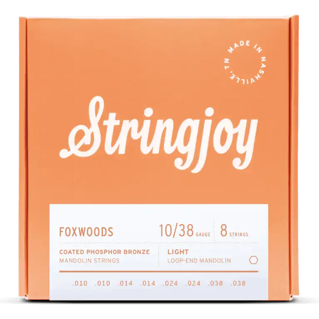 The image shows a package of Stringjoy Foxwoods coated phosphor bronze mandolin strings, light gauge 10-38, with 8 loop-end strings (.010 to .038). The box is orange/coral with white lettering and a "Made in Nashville" badge in the top right. The front has a white product label. Stringjoy is known for premium, made-in-USA strings offering warm tone and extended life.