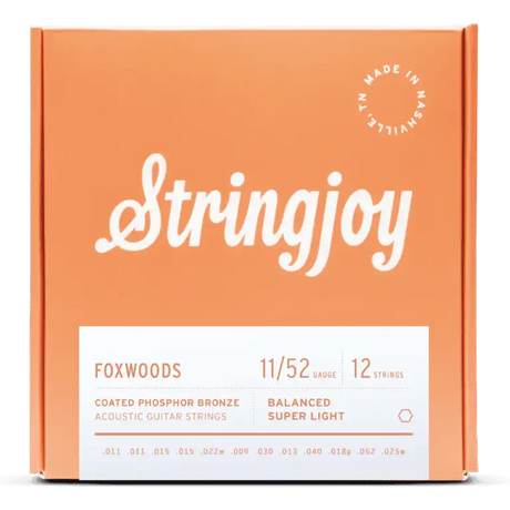 The image shows a package of Stringjoy Foxwoods coated phosphor bronze acoustic guitar strings for 12-string guitars. The balanced super light set is gauge 11/52. The orange/coral box features the Stringjoy logo, technical specs on a white label, a "Made in Nashville" badge, and lists individual string gauges. The packaging suggests a premium, corrosion-resistant string set.