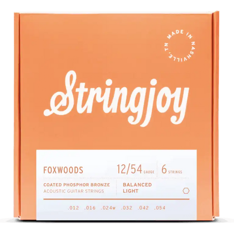 The image shows a package of Stringjoy Foxwoods coated phosphor bronze acoustic guitar strings. It features a 6-string set with 12/54 balanced light gauge (.012, .016, .024w, .032, .042, .054). The orange box has white text, a “Made in Nashville” logo, and a modern, professional design. These strings offer a bright, warm tone with enhanced durability and easier playability.