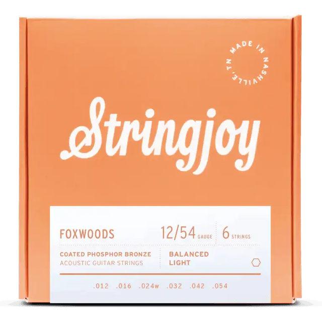 The image shows a package of Stringjoy Foxwoods coated phosphor bronze acoustic guitar strings. It features a 6-string set with 12/54 balanced light gauge (.012, .016, .024w, .032, .042, .054). The orange box has white text, a “Made in Nashville” logo, and a modern, professional design. These strings offer a bright, warm tone with enhanced durability and easier playability.
