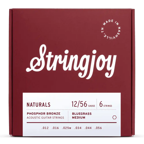 The image shows a package of Stringjoy acoustic guitar strings from the "Naturals" line. It features a burgundy box with white script, a "Made in Nashville, TN" stamp, and a white label with specs. The set includes 6 phosphor bronze strings, gauge 12/56 (medium), with tensions labeled "Bluegrass Medium," designed for warm tone and balanced playability.