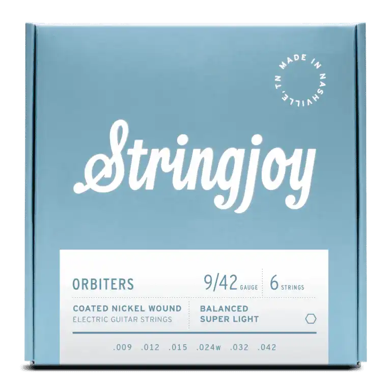 The image shows a package of Stringjoy Orbiters electric guitar strings, gauge 9-42, a 6-string set of balanced super light coated nickel wound strings. The box features a modern blue-gray design with white text and a "Made in Nashville" stamp. These premium strings offer easier playability and extended life, ideal for players seeking light tension and good tone.