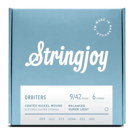 The image shows a package of Stringjoy Orbiters electric guitar strings, gauge 9-42, a 6-string set of balanced super light coated nickel wound strings. The box features a modern blue-gray design with white text and a "Made in Nashville" stamp. These premium strings offer easier playability and extended life, ideal for players seeking light tension and good tone.