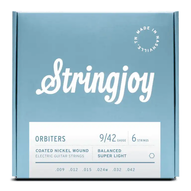 The image shows a package of Stringjoy Orbiters electric guitar strings, gauge 9-42, a 6-string set of balanced super light coated nickel wound strings. The box features a modern blue-gray design with white text and a "Made in Nashville" stamp. These premium strings offer easier playability and extended life, ideal for players seeking light tension and good tone.