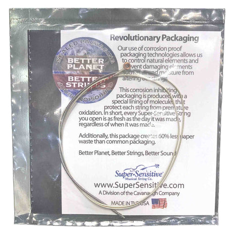The image shows packaging for Super-Sensitive Musical String Co. guitar strings, featuring corrosion-proof, molecular-lined sealed packaging that protects against oxidation and moisture. It highlights a “Better Planet, Better Strings, Better Sound” tagline, 60% less paper waste, and sustainability efforts. Made in the USA by a Cavanaugh Company division, the packaging combines environmental care with superior string protection.