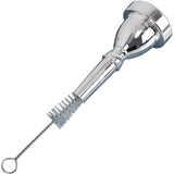 The image shows a silver-plated trumpet mouthpiece with a polished finish alongside a cleaning brush. The brush has a twisted wire handle and bristles designed to clean the inside bore and cup of the mouthpiece. This essential accessory helps brass players maintain hygiene and sound quality by removing buildup from daily use, keeping their instrument in optimal playing condition.