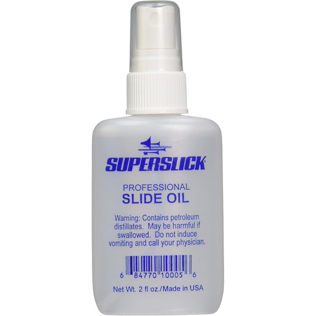 The image shows a 2 fl oz clear plastic spray bottle of Superslick Professional Slide Oil for brass instruments. The label features a blue Superslick logo and a safety warning about petroleum distillates. This lubricating oil helps trombone and trumpet slides move smoothly, preventing sticking and ensuring optimal performance and longevity of brass instruments.