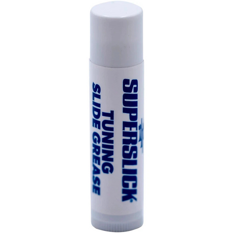 The image shows a white cylindrical slide grease stick labeled "SUPERSTICK" and "TUNING SLIDE GREASE" in blue text. This essential brass instrument accessory helps keep tuning slides smooth, prevents corrosion and sticking, maintains tuning adjustments, and protects metal parts. Its stick form allows easy application to slides on trumpets, trombones, French horns, and tubas for regular maintenance.