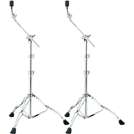 The image shows a pair of professional chrome-plated boom cymbal stands with sturdy tripod bases and rubber feet for stability. Each stand has adjustable height sections, angled boom arms for flexible positioning, wing nuts for securing adjustments, and cymbal felts at the top for mounting cymbals. These stands help drummers position cymbals at desired heights and angles, especially in tight drum kit setups.