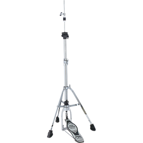 The image shows a professional-grade hi-hat stand with a tall chrome telescoping pole, tripod base with rubber feet, and foot pedal mechanism to open and close two cymbals. It features adjustment clamps along the stand and supports typical hi-hat cymbals (13"-15"). Pressing the pedal brings the cymbals together for the "chick" sound, essential for an acoustic drum kit.