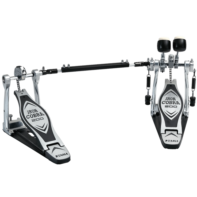 The image shows a Tama Iron Cobra 200 series double bass drum pedal with two connected foot pedals and a chain drive system. It features chrome and black metal construction, adjustable black beaters, wide footplates for stability, and branding on the pedal plates. Designed for fast, complex bass drum patterns, it’s popular in rock and metal for smooth, durable performance.
