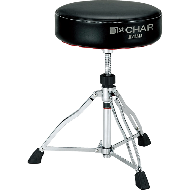 The image shows a Tama drum throne from the "1st Chair" series with a round, padded black vinyl seat. It features an adjustable height threaded rod, a sturdy chrome tripod base with rubber feet for stability, and professional-grade construction. This durable stool provides comfort and optimal seating for drummers during long sessions, reflecting Tama’s reputation for high-quality percussion accessories.