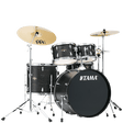 The image shows a complete Tama acoustic drum kit with a bass drum, snare, multiple tom-toms, and a floor tom. It includes chrome hardware, pedals, and two Meinl cymbals (a larger crash/ride on the left and a smaller cymbal on the right). The drums have a dark wood grain or black finish. This versatile setup is suitable for various musical styles like rock, jazz, and pop.