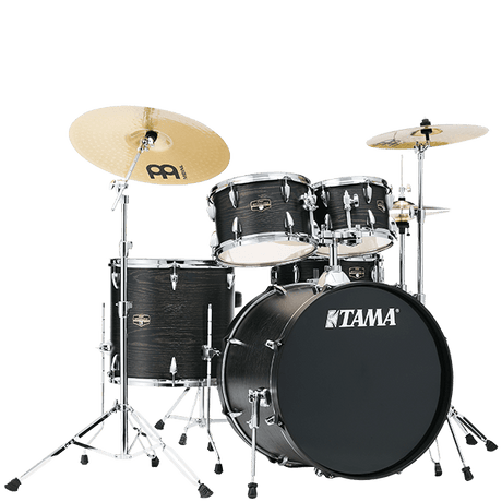 The image shows a complete Tama acoustic drum kit with a bass drum, snare, multiple tom-toms, and a floor tom. It includes chrome hardware, pedals, and two Meinl cymbals (a larger crash/ride on the left and a smaller cymbal on the right). The drums have a dark wood grain or black finish. This versatile setup is suitable for various musical styles like rock, jazz, and pop.