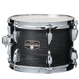 The image shows a Tama Imperial Star tom-tom drum with a dark wood grain finish and chrome hardware. It features multiple tuning lugs, standard drum heads, and a medium size, likely 10" or 12" in diameter. This drum is part of an intermediate-level kit, known for quality construction and a professional look with its chrome components and attractive wood finish.