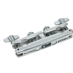 The image shows a Tama FastClamp, a polished chrome drum hardware clamp designed to mount percussion accessories like cowbells or woodblocks. It features Tama branding, dual adjustable wing nuts for secure attachment, and multi-angle adjustment for precise positioning. This professional-grade clamp attaches to drum stands or racks, providing reliable, quick setup for expanding drum kits with additional instruments.