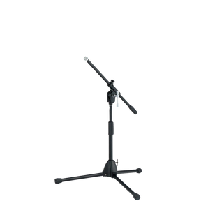 The image shows a professional black microphone stand with a tripod base and an adjustable boom arm. It has multiple height and angle adjustment points with locking mechanisms for stability. This versatile stand is commonly used by musicians, vocalists, and audio engineers to position microphones for recording, live performances, and studio work.