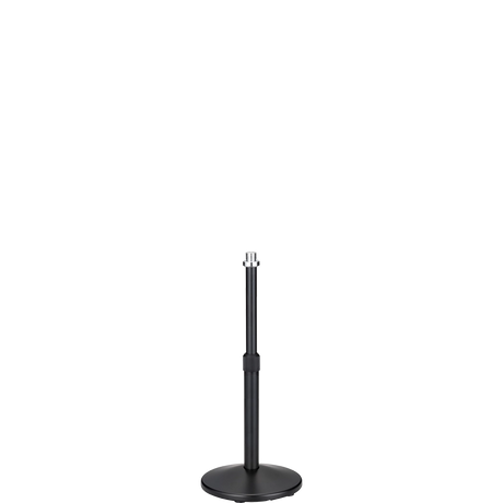 The image shows a black microphone stand with a round, weighted base and an adjustable telescoping pole. It features a microphone clip at the top for holding a microphone. Commonly used in live performances, studios, and broadcasting, the stand’s height adjustment and sturdy base ensure stability and optimal microphone placement for vocals and instruments.