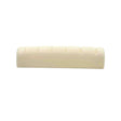 The image shows a guitar nut, a small rectangular piece made of bone or synthetic material, with grooves to hold and space the strings. It sits between the headstock and neck, before the first fret. This nut appears unfinished, needing final fitting and slotting. Guitar nuts are vital for string height, spacing, and playability, and can be made from materials like bone, brass, or graphite, affecting tone and durability.