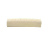 The image shows a guitar nut, a small rectangular piece made of bone or synthetic material, with grooves to hold and space the strings. It sits between the headstock and neck, before the first fret. This nut appears unfinished, needing final fitting and slotting. Guitar nuts are vital for string height, spacing, and playability, and can be made from materials like bone, brass, or graphite, affecting tone and durability.