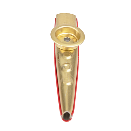 Gold metal kazoo with a red bottom on a white background