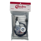 The image shows a Chesbro Music Co. trumpet care kit containing essential items for maintenance: a bottle of valve oil with blue liquid, black cleaning brushes or snakes, a small white container of slide grease or lubricant, and instructional materials. Packaged in a clear plastic bag with branding, this kit helps trumpet players keep their instrument clean, lubricated, and in good working condition.