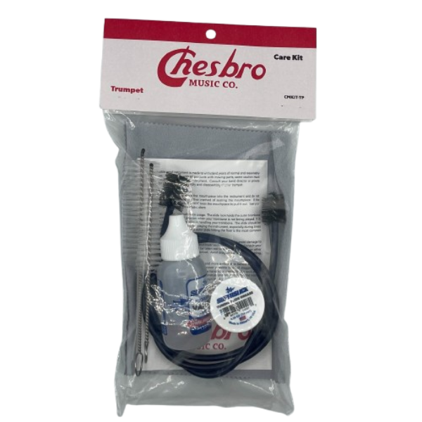 The image shows a Chesbro Music Co. trumpet care kit containing essential items for maintenance: a bottle of valve oil with blue liquid, black cleaning brushes or snakes, a small white container of slide grease or lubricant, and instructional materials. Packaged in a clear plastic bag with branding, this kit helps trumpet players keep their instrument clean, lubricated, and in good working condition.