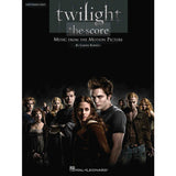 The image shows a piano sheet music book titled "Twilight: The Score" with easy piano solo arrangements from the film's soundtrack by Carter Burwell. Published by Hal Leonard, the cover features the main Twilight characters and logo. This book is designed for intermediate pianists to learn and play recognizable music from the movie’s score.