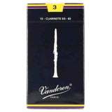 The image shows a box of Vandoren clarinet reeds, marked "10 - Clarinette Sib - Bb" for B♭ clarinet. It features the Vandoren brand name and "PARIS," a white clarinet silhouette on dark blue-black packaging with purple and yellow accents. The reed strength is 3, indicated by a yellow number at the top, representing medium stiffness suitable for intermediate to advanced players.