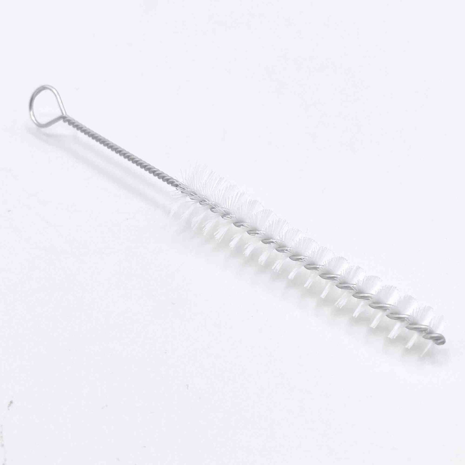 The image shows a cleaning brush for musical instruments, featuring a long, flexible wire handle with a hanging loop and white cylindrical bristles. Its slender design is ideal for cleaning narrow tubes and bores of wind, brass, and woodwind instruments like flutes, clarinets, trumpets, and saxophones. This essential tool helps remove moisture and debris to maintain sound quality and instrument longevity.