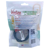 The image shows a Venture Pro-Quality trombone care kit containing essential maintenance items: premium slide oil, slide grease, mouthpiece and flexible bore brushes, a polishing cloth, and a case ID tag. This comprehensive kit helps trombone players clean and lubricate their instrument, ensuring optimal performance and preservation of the finish. Made in the USA, it provides specialized accessories for proper brass instrument care.