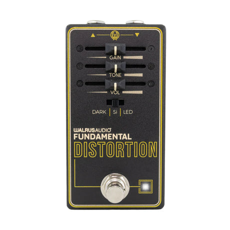The image shows the Walrus Audio Fundamental Distortion guitar effects pedal. It features three knobs—Gain (distortion), Tone (frequency shaping), and Volume (output level)—plus a three-position toggle switch (DARK | SI | LED) for clipping modes. It has a chrome footswitch, LED indicator, input/output jacks, and a black and yellow/gold design. This pedal adds overdrive and distortion effects to electric guitars.