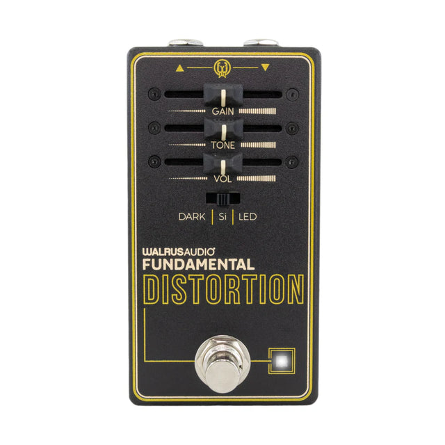The image shows the Walrus Audio Fundamental Distortion guitar effects pedal. It features three knobs—Gain (distortion), Tone (frequency shaping), and Volume (output level)—plus a three-position toggle switch (DARK | SI | LED) for clipping modes. It has a chrome footswitch, LED indicator, input/output jacks, and a black and yellow/gold design. This pedal adds overdrive and distortion effects to electric guitars.