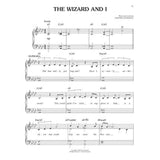 The image shows sheet music for "The Wizard and I" from Wicked by Stephen Schwartz, arranged for piano and voice in A♭ major, 4/4 time. It features piano staves with treble and bass clefs, chord symbols, a vocal melody with lyrics like "Did that really just happen?" and dynamic marking "mp." Page 15 of a professionally published musical theater score is visible.