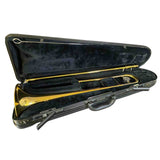 The image shows a Yamaha brass trombone in its black hard case with a dark velvet interior. The trombone features the classic golden finish and slide mechanism. The case includes combination locks and a handle. This professional-quality instrument is used in orchestras, jazz bands, and more, producing sound by buzzing lips in the mouthpiece and changing pitch with the slide.